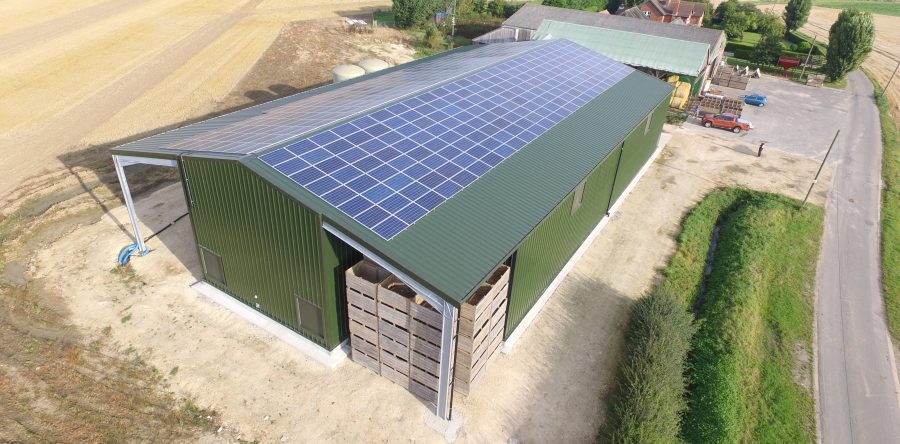 A roof-mounted solar array on an agricultural building
