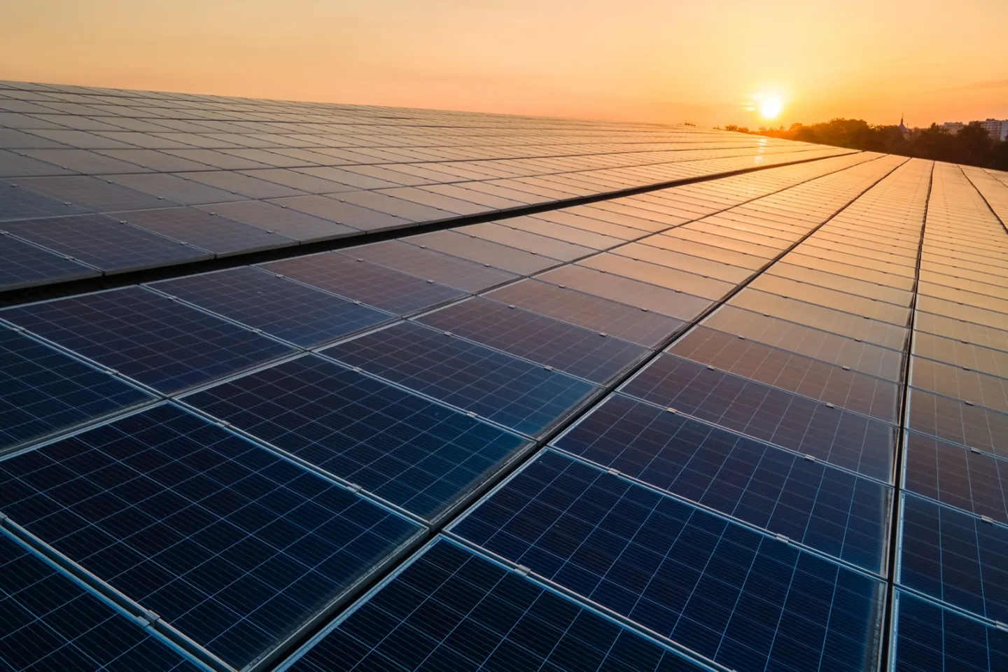 A roof-mounted solar array under a morning sky